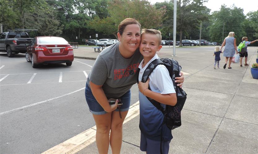 A mother and son smile